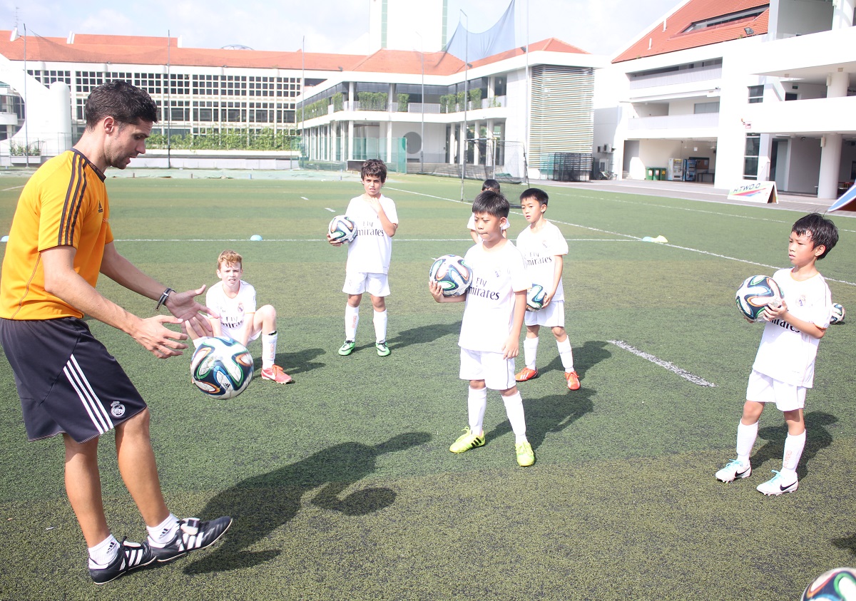 Coach Rafael demonstrating the need for focus when handling the ball